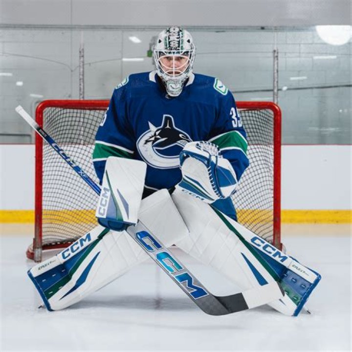 Can a player kick the ball out of goalie's hands?