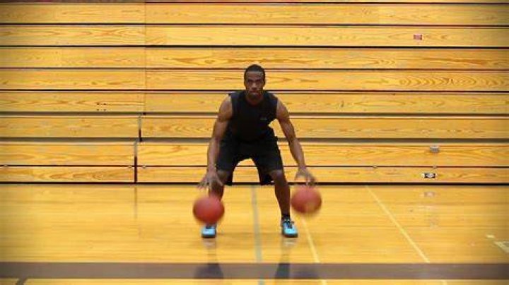 Is it legal to dribble with two hands?