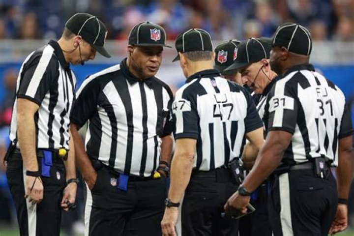 Why do refs wear white and black?